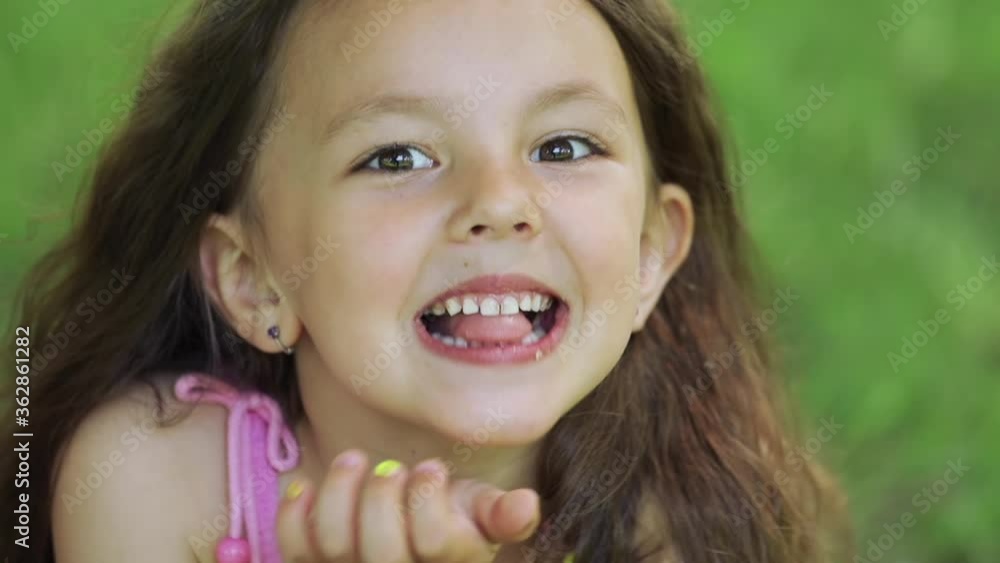 The little girl makes faces and points her tongue at the camera. The little girl makes faces and points her tongue at the camera.