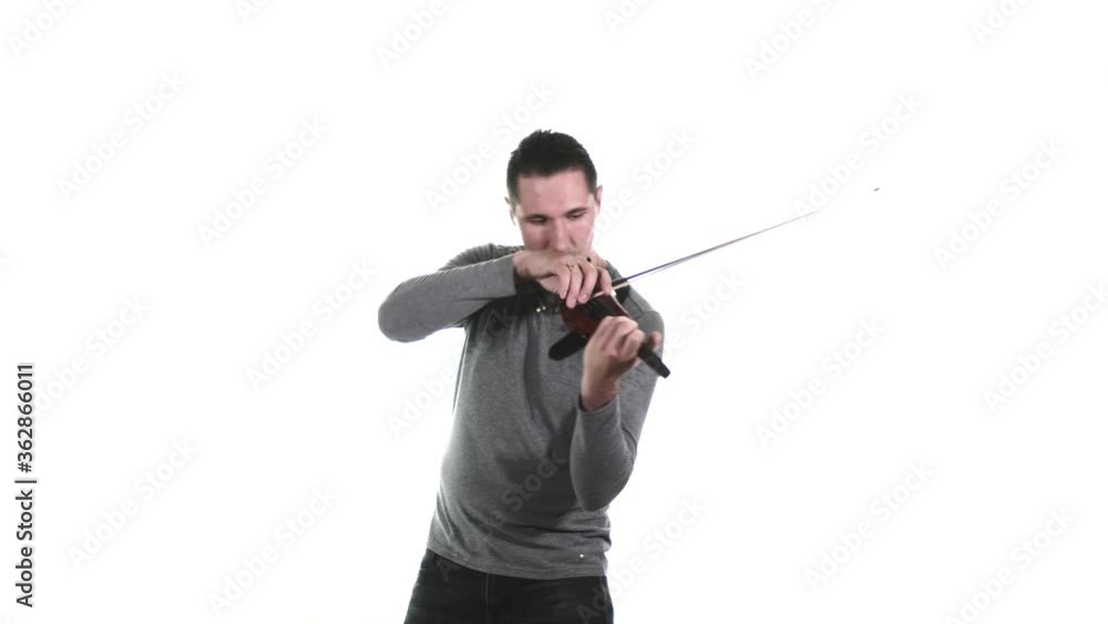 Medium long shot of young male violinist playing an electric violin. Isolated Medium long shot of young male violinist playing an electric violin. Isolated