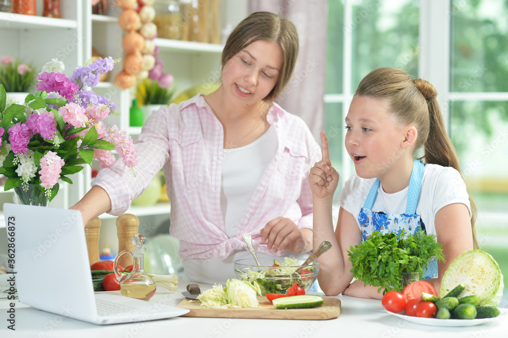 Portrait of funny girls preparing fresh salad