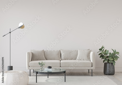 living room in light tones with a sofa, a floor lamp, a glass table and a leather pouf © J.Zhuk
