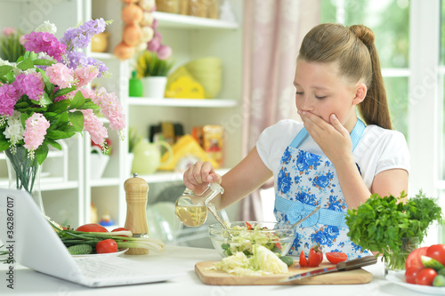 Portrait of cute teen girl preparing fresh salad