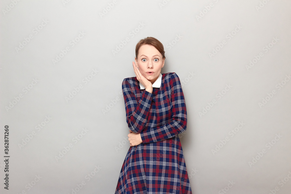 Portrait of shocked excited young woman touching cheek with hand Portrait of shocked excited young woman touching cheek with hand