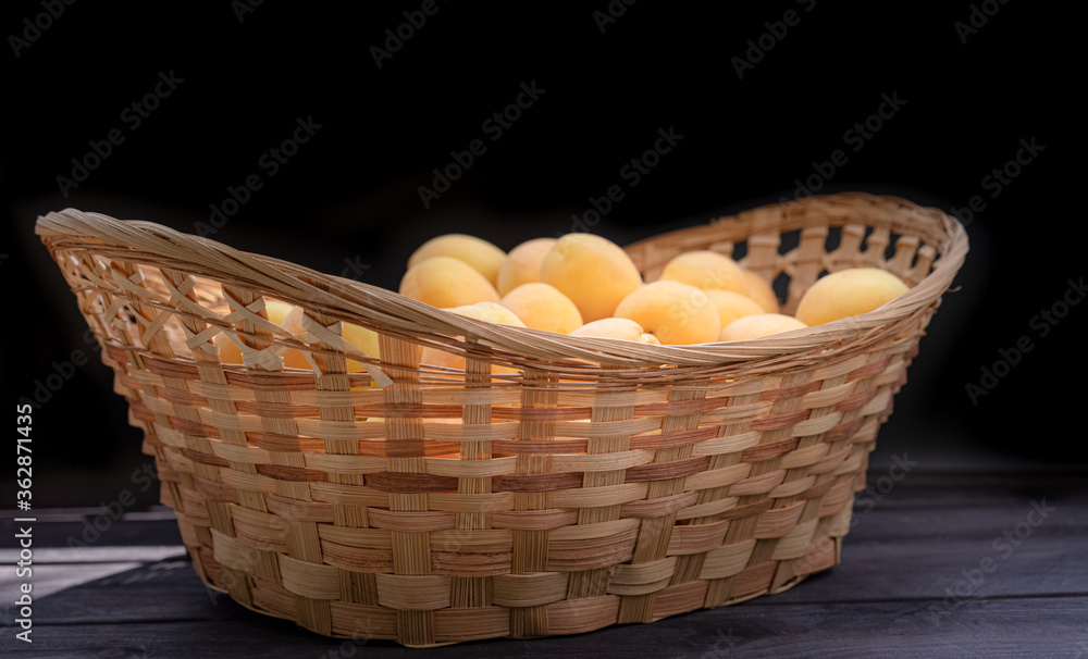 Ripe apricots on a wooden background