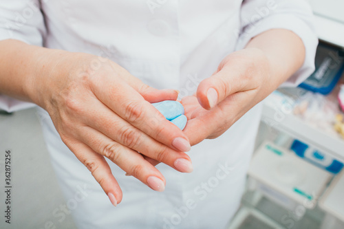 Process of molded individual hearing aid ear molds. Audiologist prepares silicone for making earplugs photo