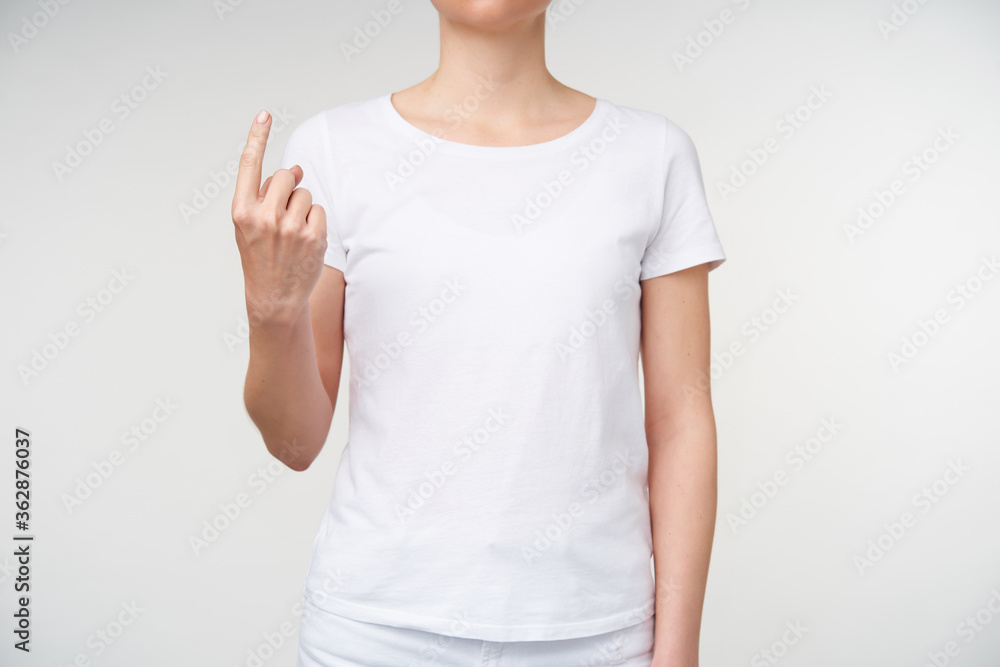 Indoor photo of young lady showing index finger while meaning word whence on sign language, isolated over white background. Hand gestures of people with hearing impairment Indoor photo of young lady showing index finger while meaning word whence on sign language, isolated over white background. Hand gestures of people with hearing impairment
