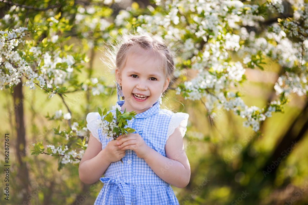 Portrait of beautiful little girl in blooming tree garden on spring day Portrait of beautiful little girl in blooming tree garden on spring day