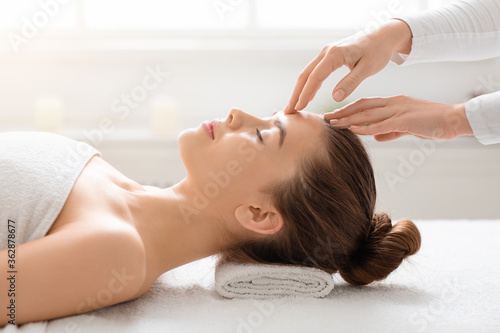 Acupressure head massage for young woman at spa