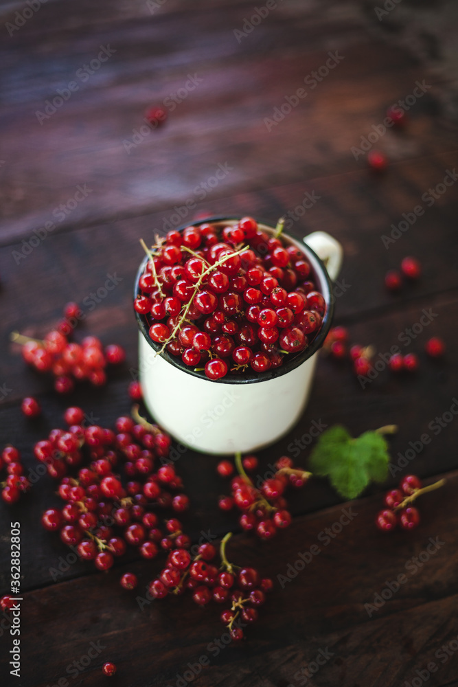 Mug overflowing with red berries on a wooden background. Berry scattered near a cup on a wooden table in the village. Flat lay
Mug overflowing with red berries on a wooden background. Berry scattered near a cup on a wooden table in the village. Flat lay
