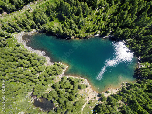 Aerial view of a blue mountain lake with forests
