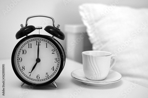 Image of coffee cup and alarm clock. 