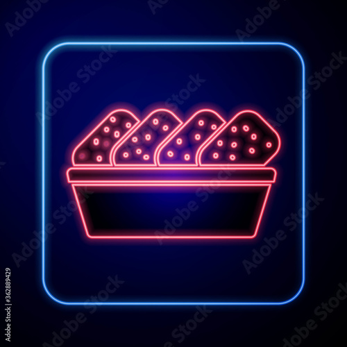 Glowing neon Chicken nuggets in box icon isolated on blue background. Vector Illustration.