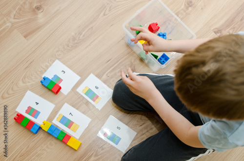 Child learning to count with blocks.