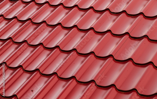 Red metal shingles roof slope, background photo
