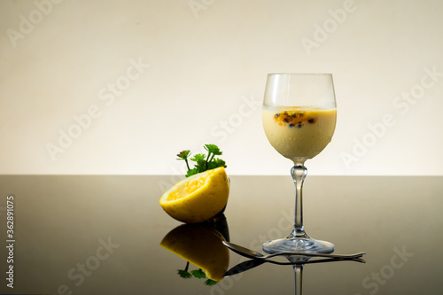 passion fruit mousse, in a glass bowl, on dark background