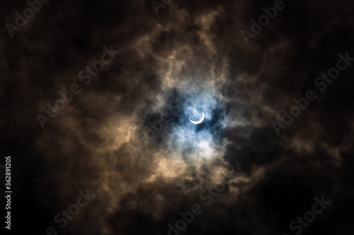 Surreal Dramatic Solar Eclipse Covered By Clouds. Natural Phenomenon.