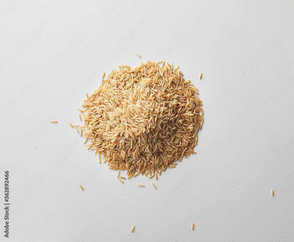 Top view shot of brown rice on white background. Top view shot of brown rice on white background.