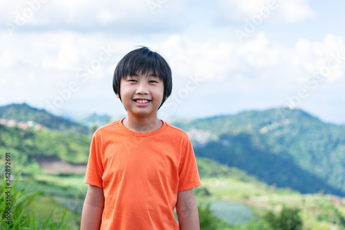 Portrait little boy with scenery mountain. Adventure concept