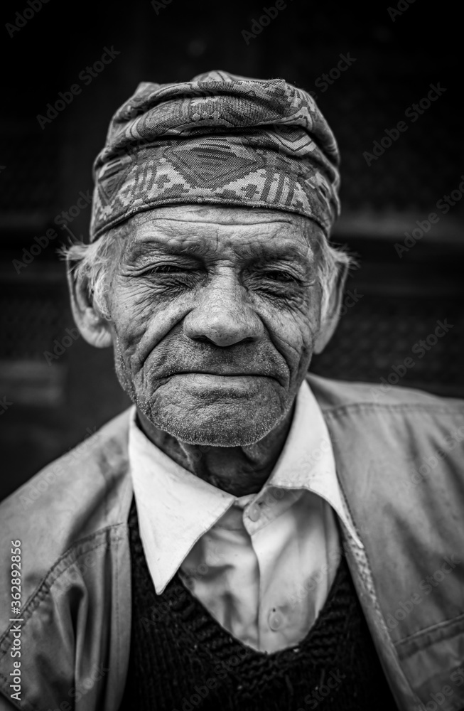 Black and White portraiture of a middle-aged Asian Man smiling at the camera.