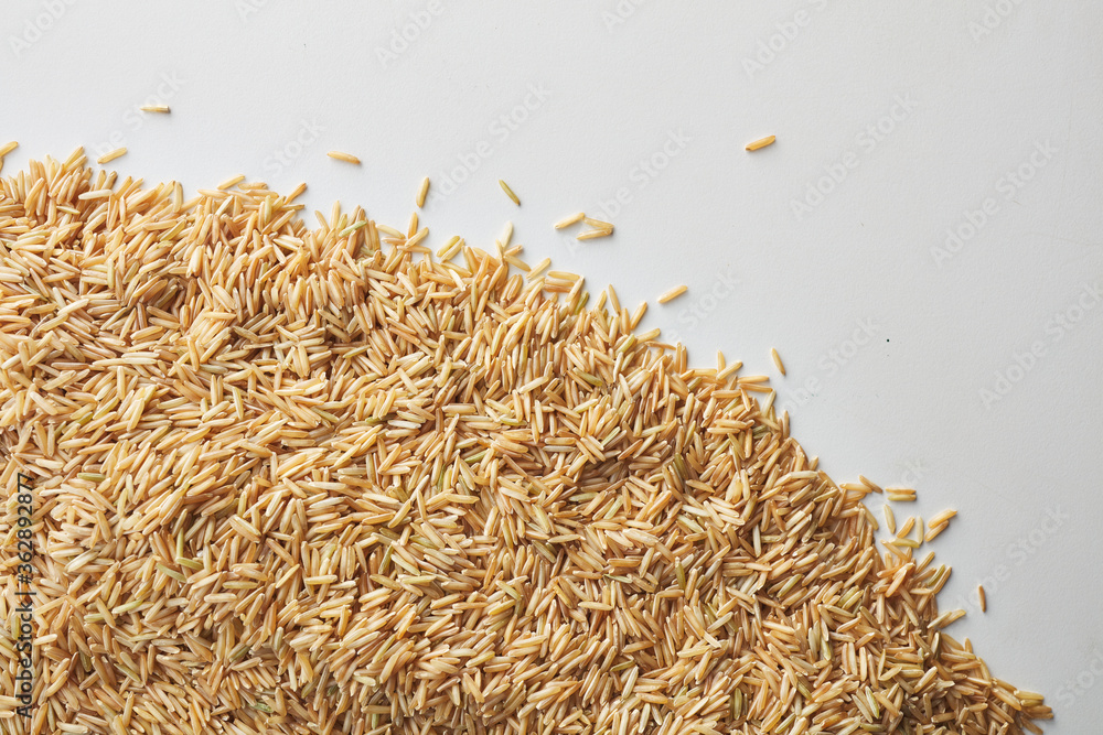 Top view shot of brown rice on white background. Top view shot of brown rice on white background.