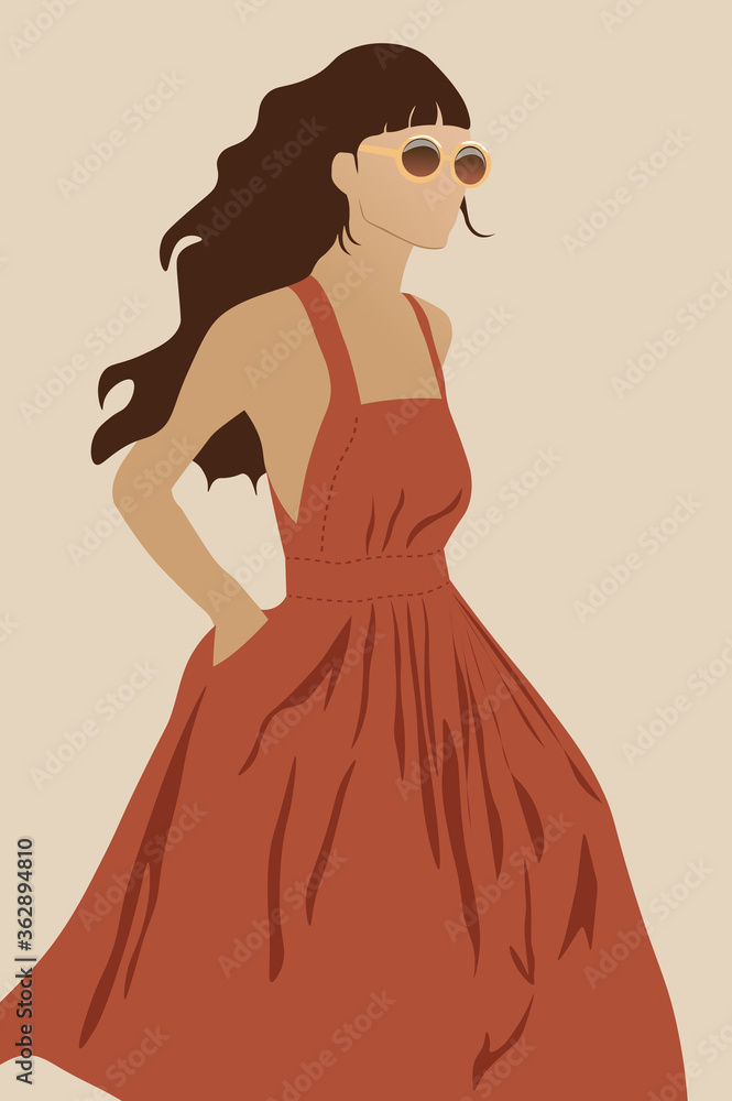 Fototapeta premium Young female model in dark orange dress and round sunglasses walking