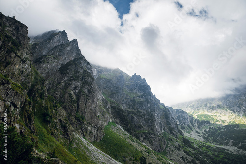Scenic view of sharp rocky mountain peaks in the dark clouds near the Morskie Oko lake, High Tatras, Zakopane, Poland