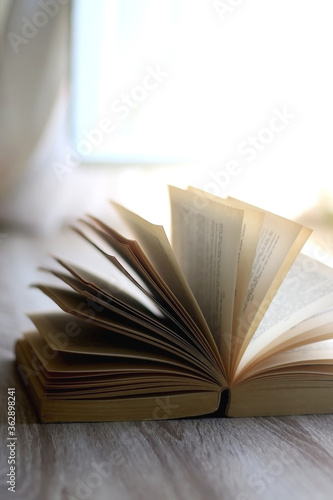 Open book on a table. Selective focus.