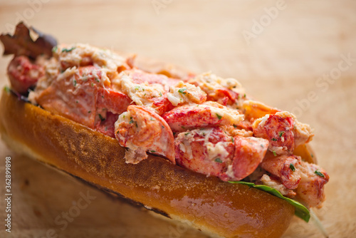 Maine Lobster Roll, traditional classic American Sandwich. New England classic, fresh Maine Lobster in homemade mayo with chives served in soft hero roll with crisp lettuce.