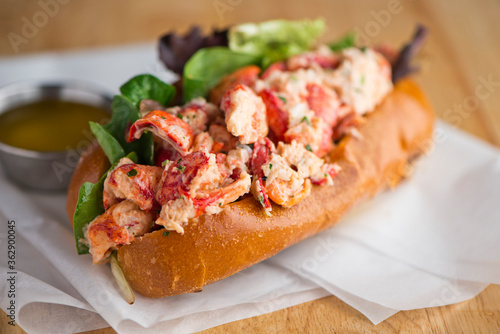 Maine Lobster Roll, traditional classic American Sandwich. New England classic, fresh Maine Lobster in homemade mayo with chives served in soft hero roll with crisp lettuce.