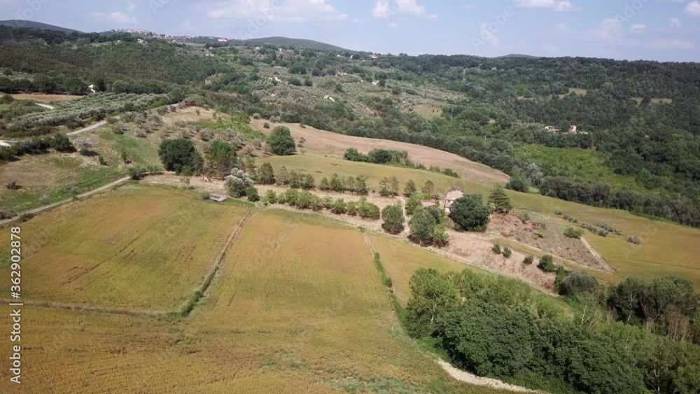 Aerial view of the Umbrian countryside with olive groves, cultivated fields and the forest in the hills Aerial view of the Umbrian countryside with olive groves, cultivated fields and the forest in the hills