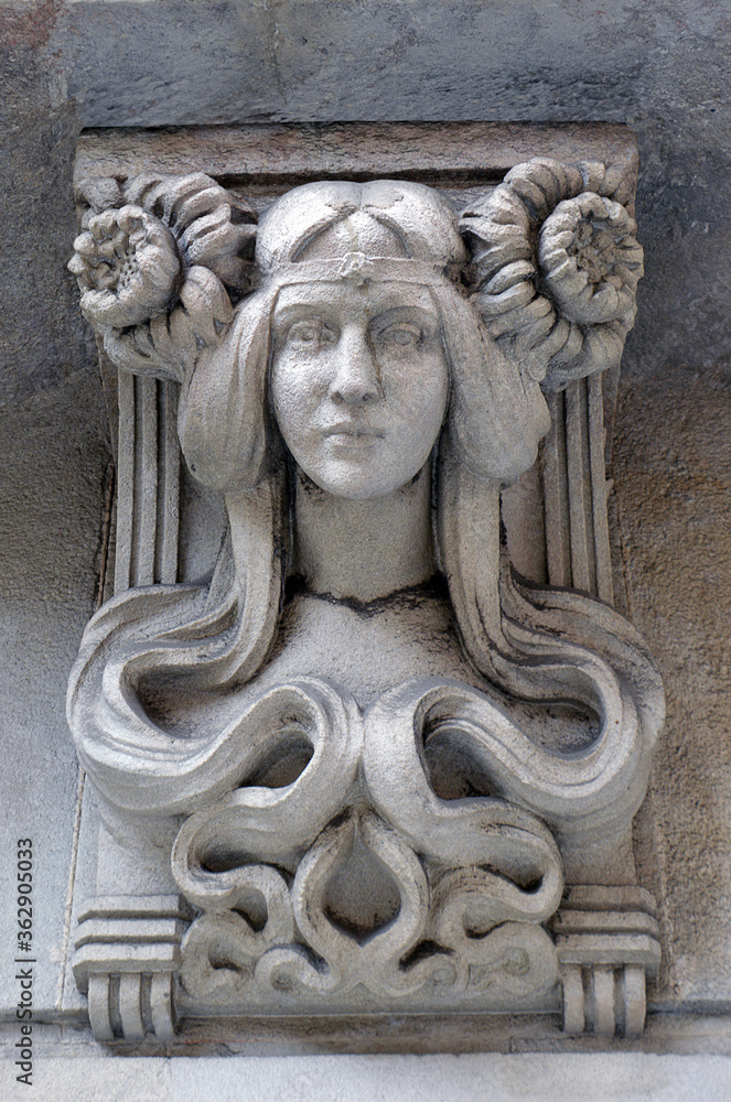 Female art deco bust on the outside wall of a Barcelona building