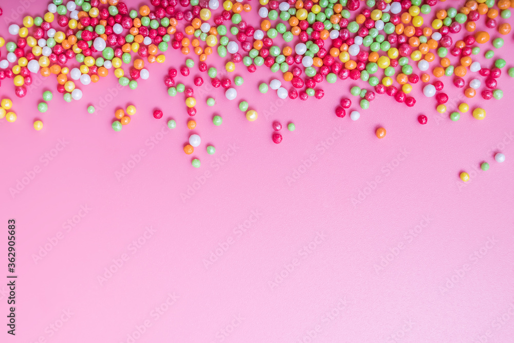 Decorative sugar sprinkles on a pink backdrop. Decorative sugar sprinkles on a pink backdrop.