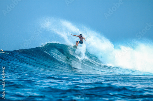Surfer on perfect blue aquamarine wave, empty line up, perfect for surfing, clean water, Indian Ocean . photo