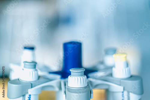Laboratory pipettes on blurred laboratory background. Research and development concept with free space for text.