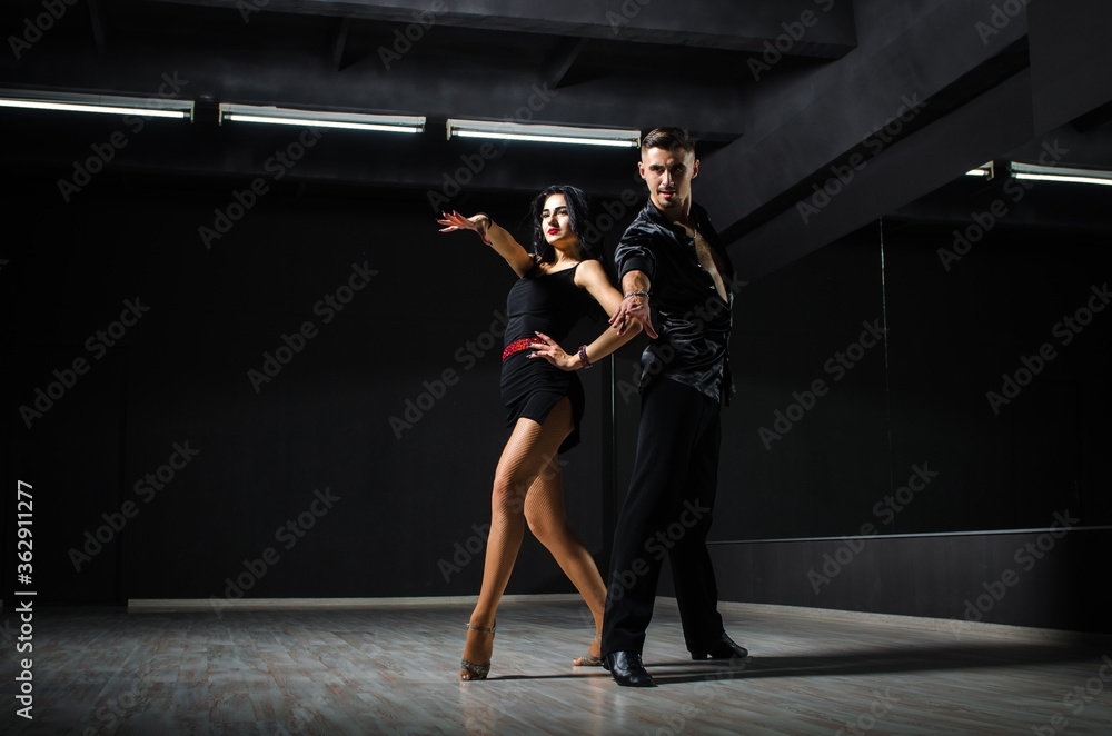 Ballroom dancers. The guy with the girl is engaged in ballroom dancing. Ballroom dancing. Dancing. The guy with the girl dancing in a dark room.
Ballroom dancers. The guy with the girl is engaged in ballroom dancing. Ballroom dancing. Dancing. The guy with the girl dancing in a dark room.