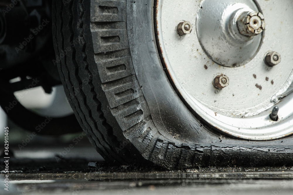 Close up of car flat tire in rainy day Close up of car flat tire in rainy day