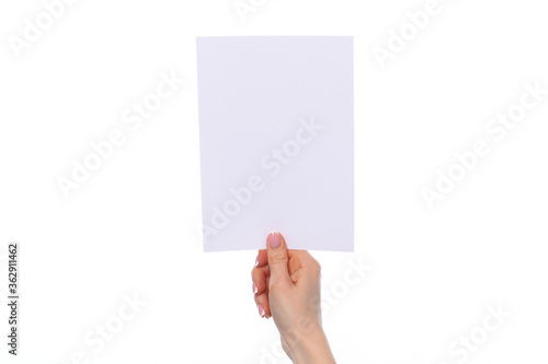 Female hand holding blank white sheet of paper isolated on white