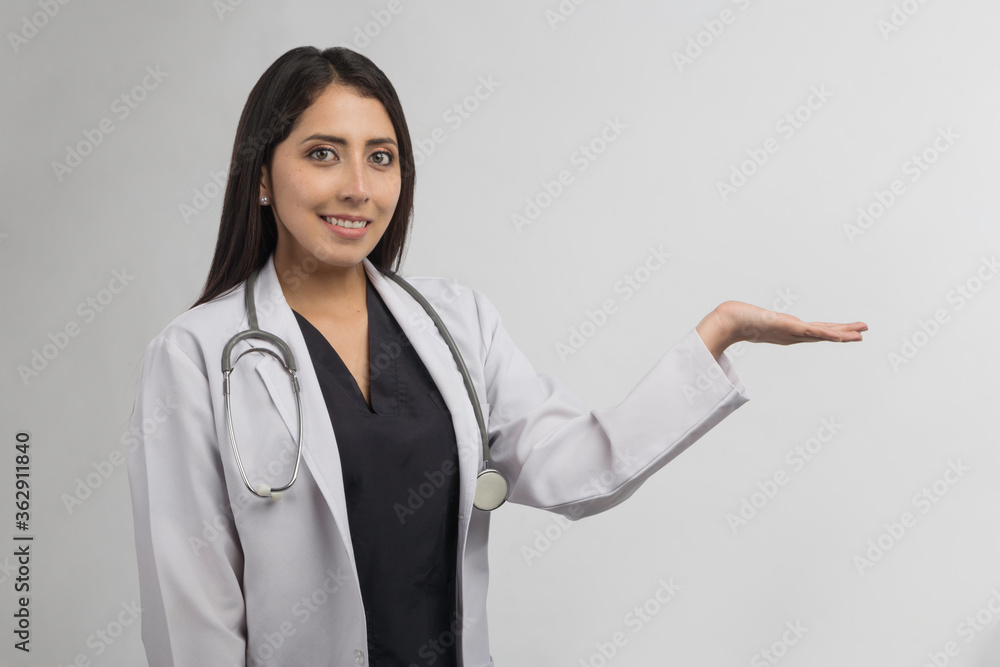 female doctor with a stethoscope on her neck pointing with one hand female doctor with a stethoscope on her neck pointing with one hand