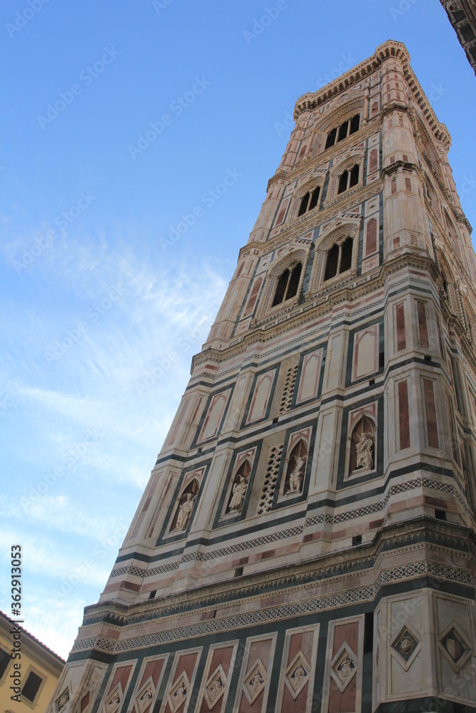 Grandiosity of the Duomo (Cattedrale di Santa Maria del Fiore), Florence against bright blue skies