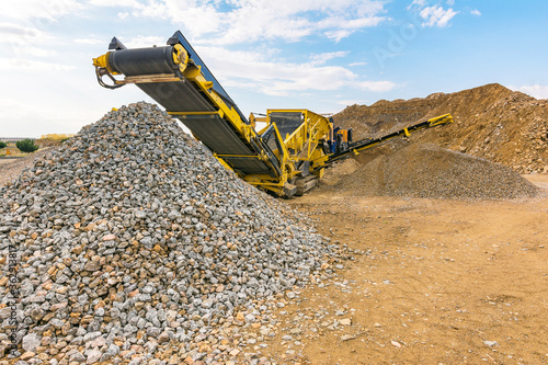 Heavy machinery for processing rock and stone in a quarry photo