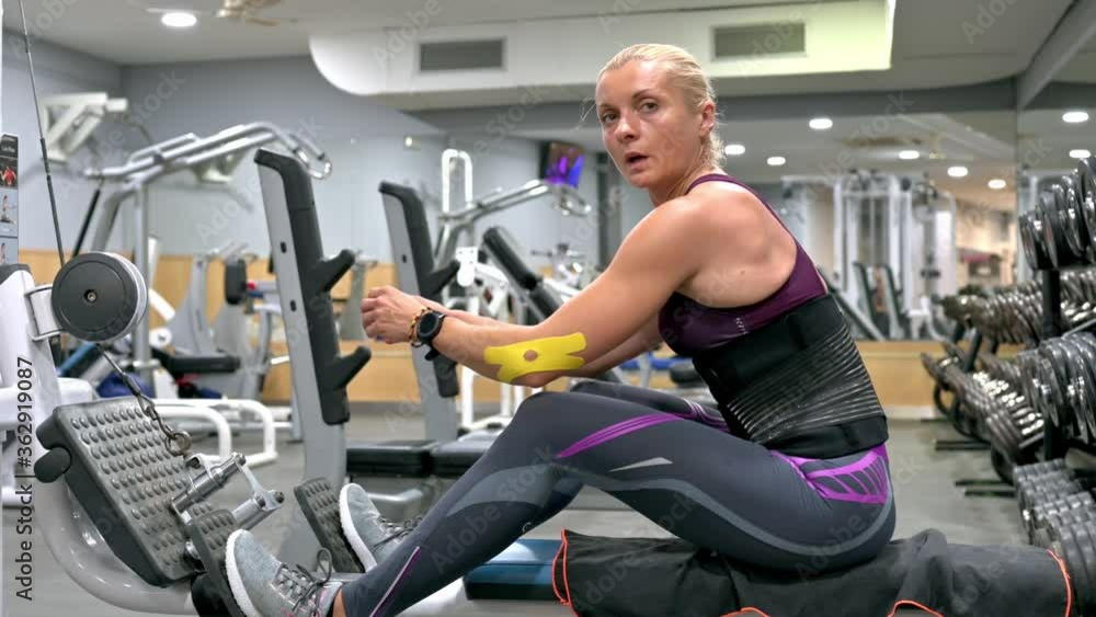 Beautiful woman goes in for sports in the fitness center Beautiful woman goes in for sports in the fitness center