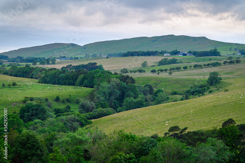 Winshield Crags viewed from Vindolanda, as Hadrians Wall sits upon the top of the Crags above the Roman Fort of Vindolanda in Northumberland. The Sill just visible on the left. © drhfoto