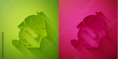 Paper cut Sherlock Holmes with smoking pipe icon isolated on green and pink background. Detective. Paper art style. Vector.