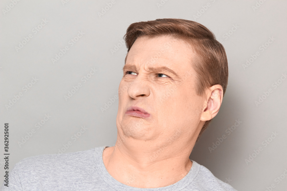 Portrait of funny man grimacing from disgust and squeamishness Portrait of funny man grimacing from disgust and squeamishness