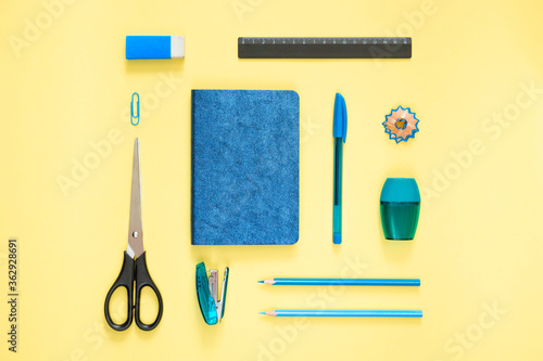 Foto Flat lay blue stationery on a yellow background