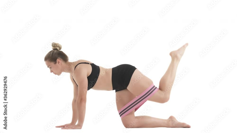 side view portrait of glutes workout for women with mini band. Isolated on white background. side view portrait of glutes workout for women with mini band. Isolated on white background.
