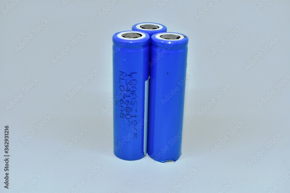 Three rechargeable 18650 lithium-ion batteries. isolated on a white background. batteries for flashlights, vapes, electronic cigarettes, laptops Three rechargeable 18650 lithium-ion batteries. isolated on a white background. batteries for flashlights, vapes, electronic cigarettes, laptops