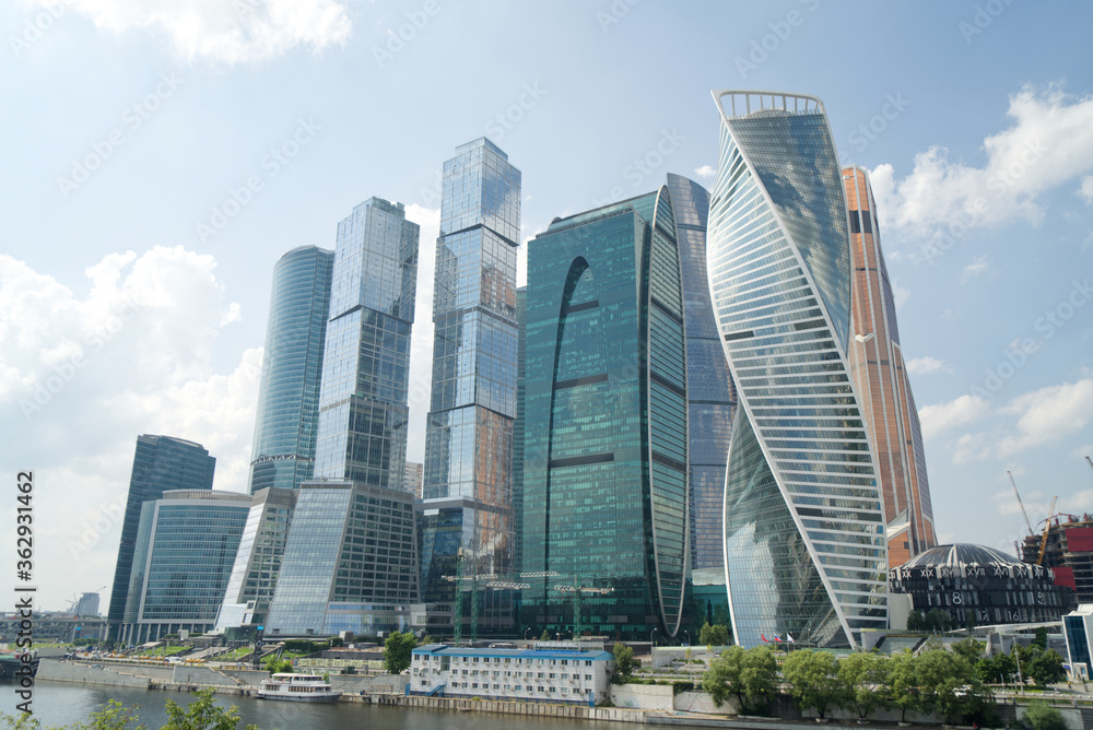 modern skyscrapers business center with blue sky and clouds, reflections on glass, Moscow city modern skyscrapers business center with blue sky and clouds, reflections on glass, Moscow city