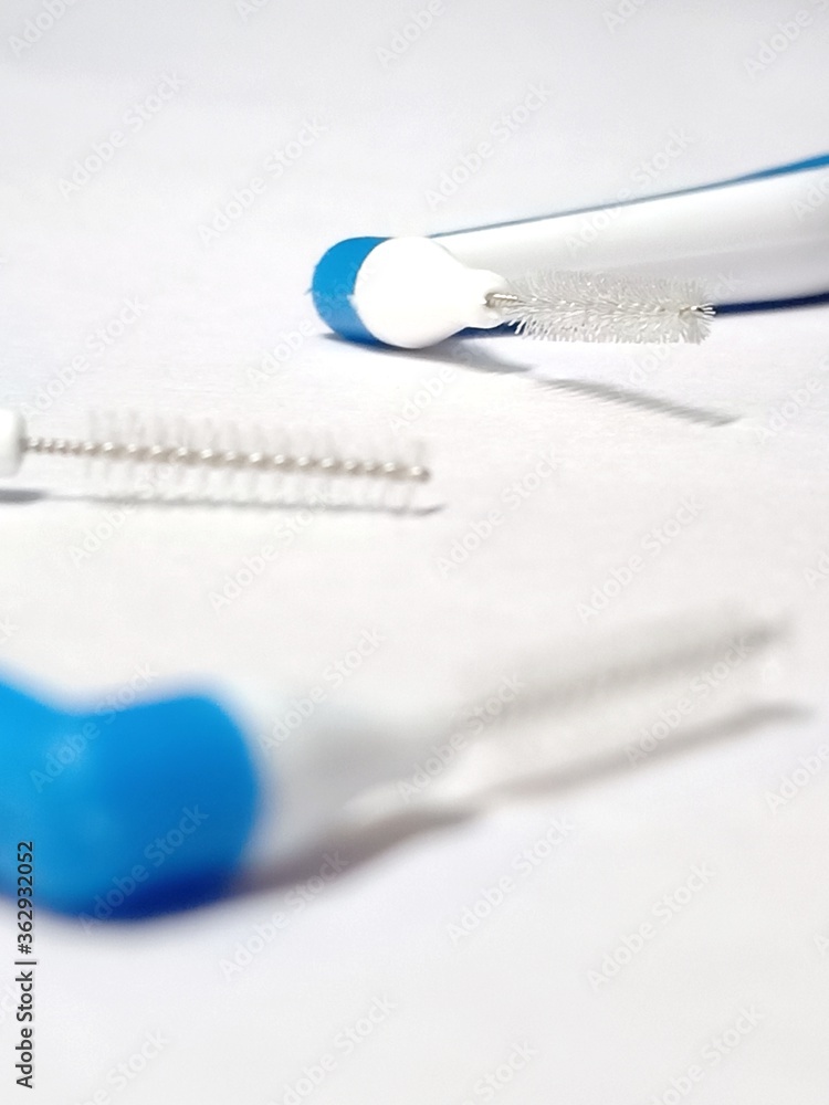 Interdental brushes isolated over white background with selective focus on subject Interdental brushes isolated over white background with selective focus on subject