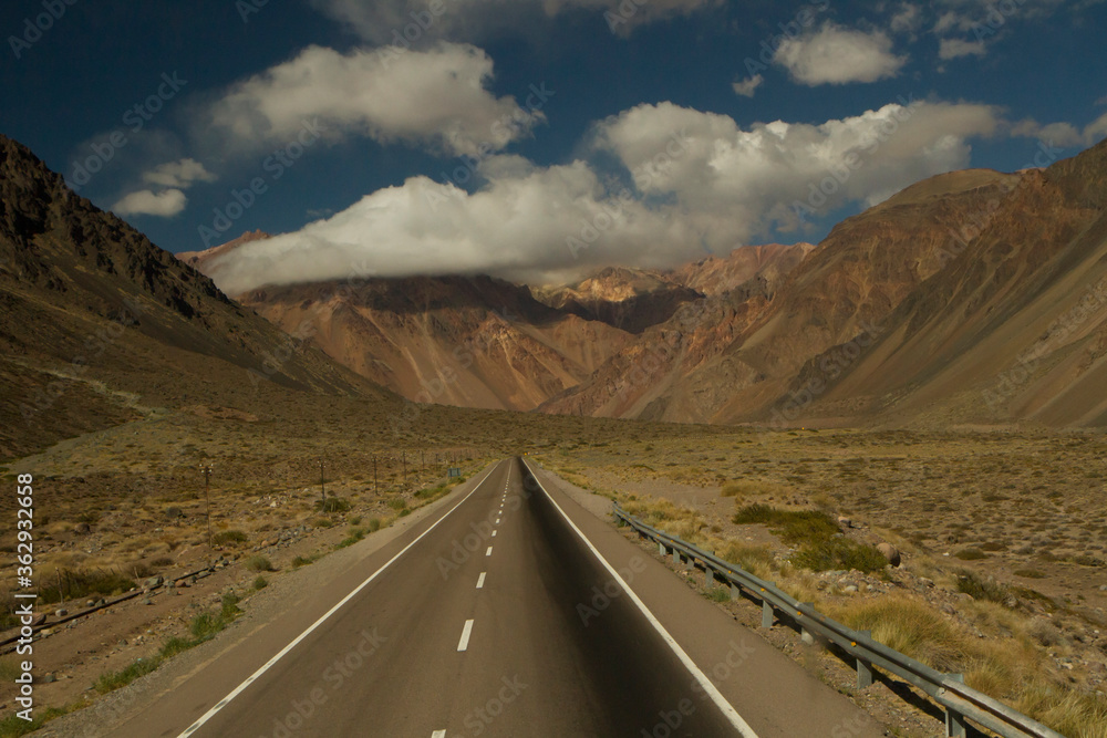 Transport. Traveling along the desert highway. Asphalt straight road into the arid mountains and valley. 