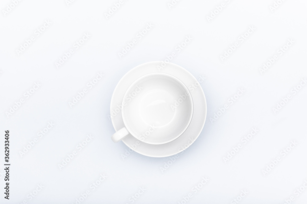 white porcelain cup on a saucer isolated on a white background white porcelain cup on a saucer isolated on a white background